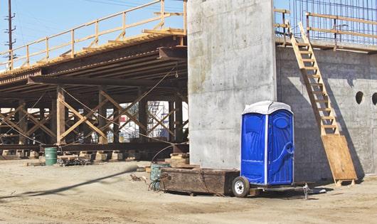 portable toilets set up for workers’ use at a busy work site